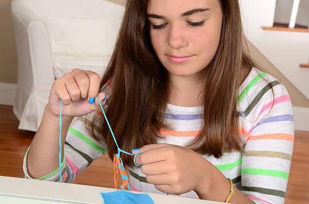 Woman Weaving A Bracelet